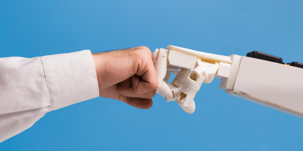 A human hand and a robot hand doing a fist bump